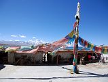 15 Seralung Gompa Courtyard Flagpole With Lake Manasarovar And Gurla Mandhata Beyond The courtyard of Seralung Gompa has a tall flagpole with a view to lake Manasarovar.